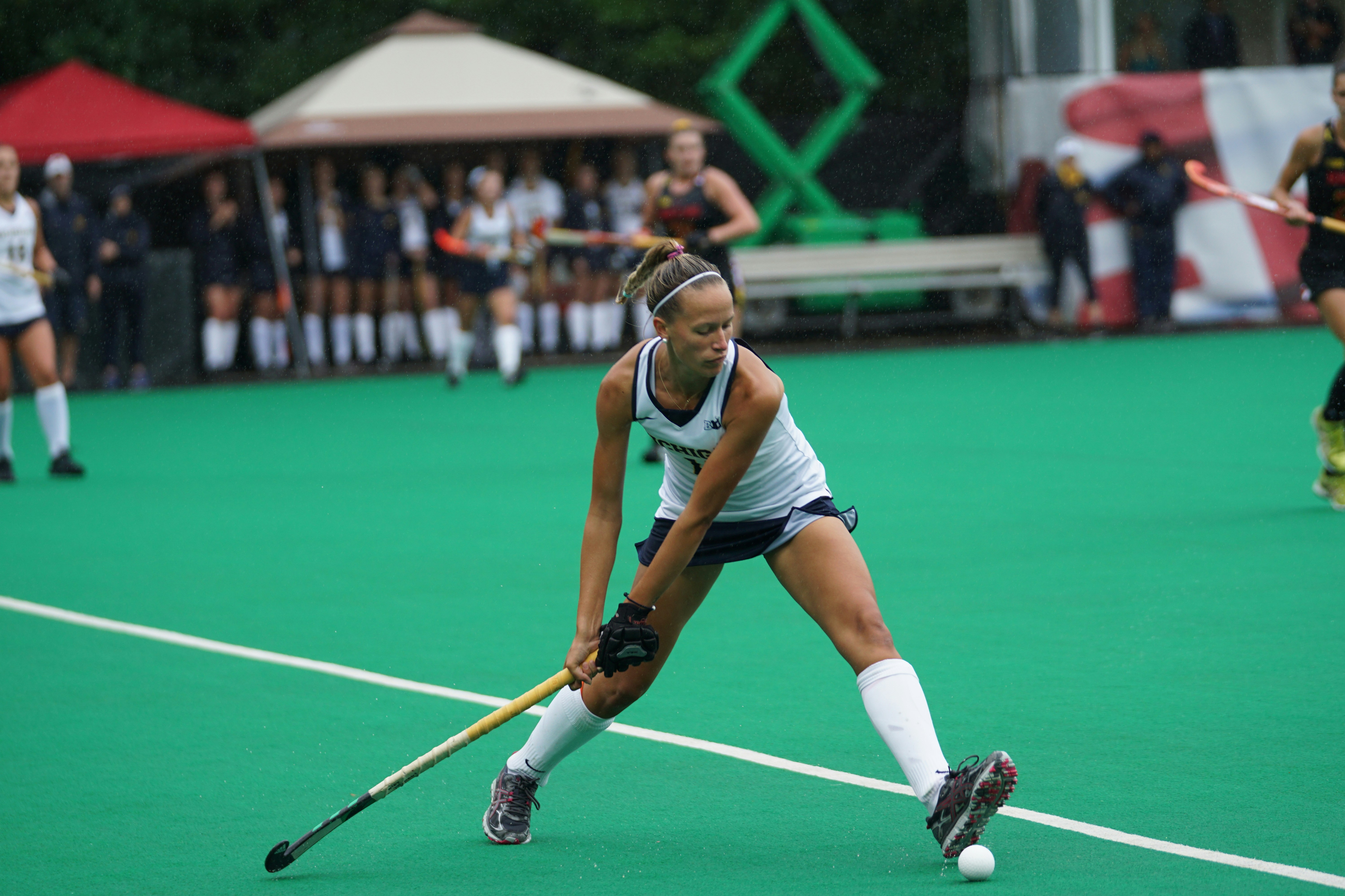 Field hockey player with stick on turf